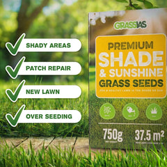 Grassias Premium Shade & Sunshine Grass Seeds 750g box displayed on a wooden surface against a soft-focus green garden background with dappled sunlight through trees. Four green tick-mark badges on the left highlight key uses: Shady Areas, Patch Repair, New Lawn, and Over Seeding. The box shows 750g net weight and 37.5m² coverage.